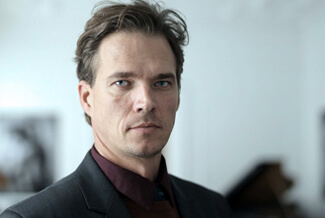 headshot of mark looking grim